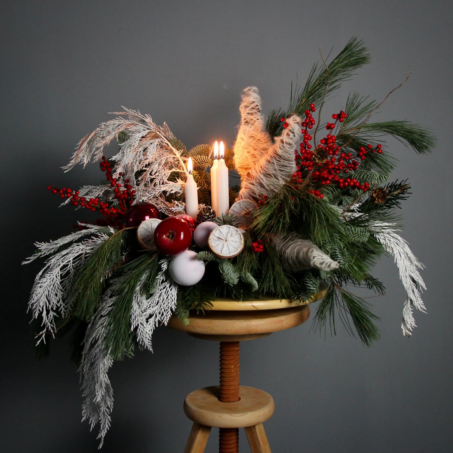 centerpiece of red berries branches of blue spruce Christmas Composition