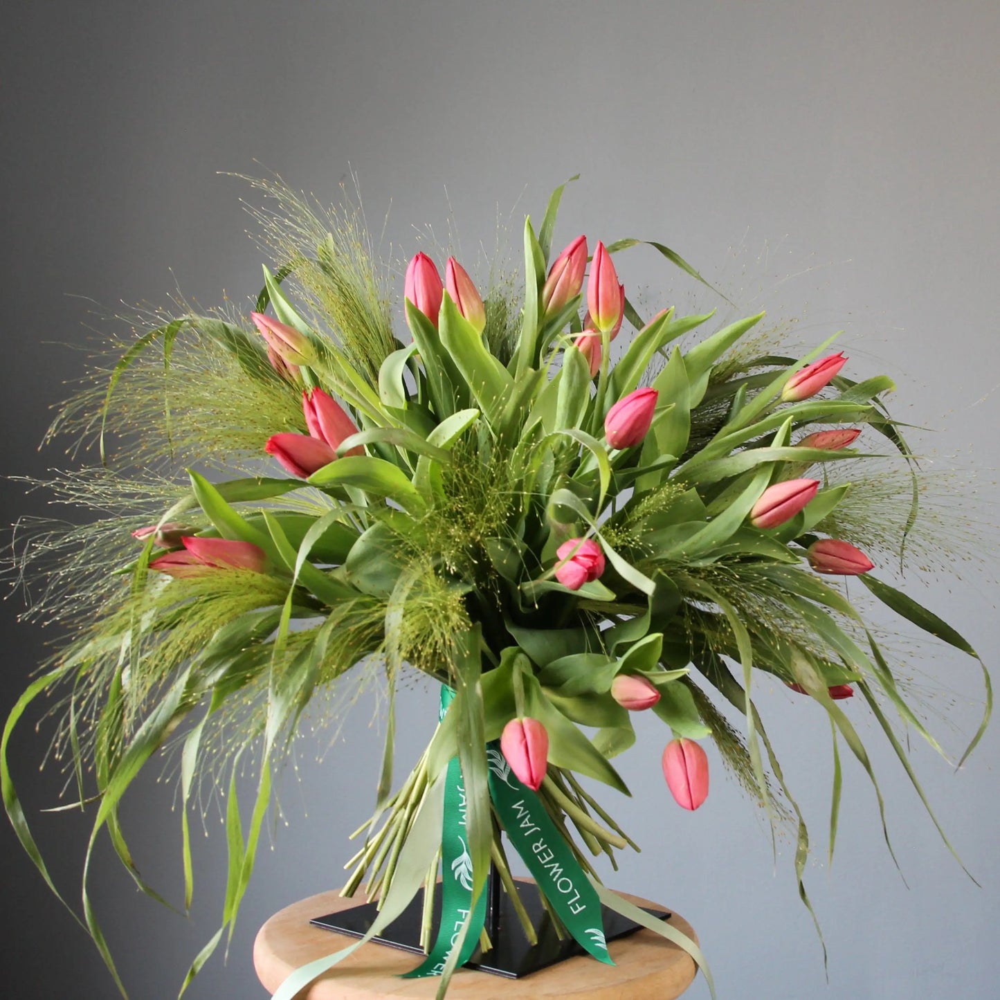 a big beautiful bouquet of pink tulips and greenery