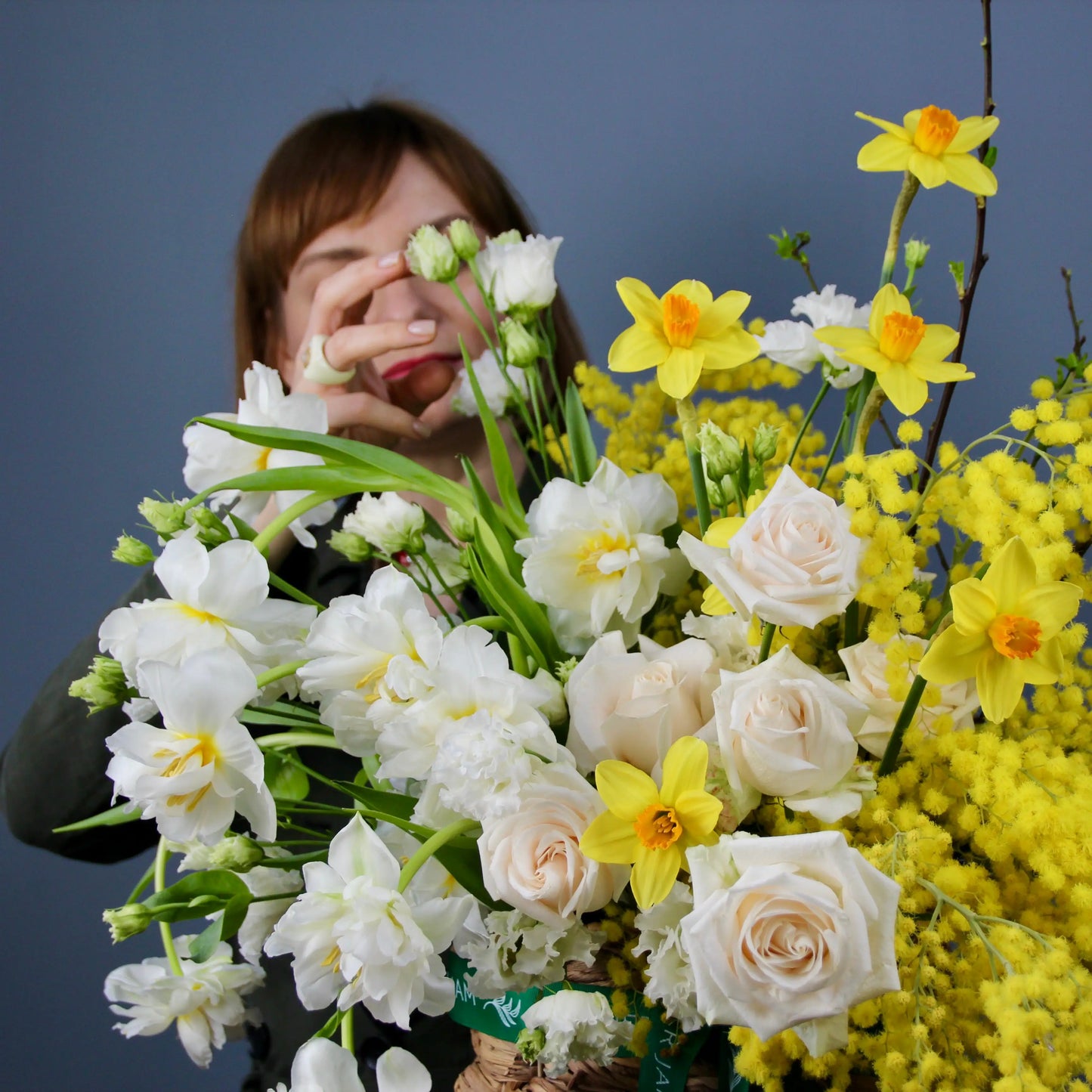 flower bouquet of mimosa, rose and narcissus in a basket floqwer bouquet in genova
