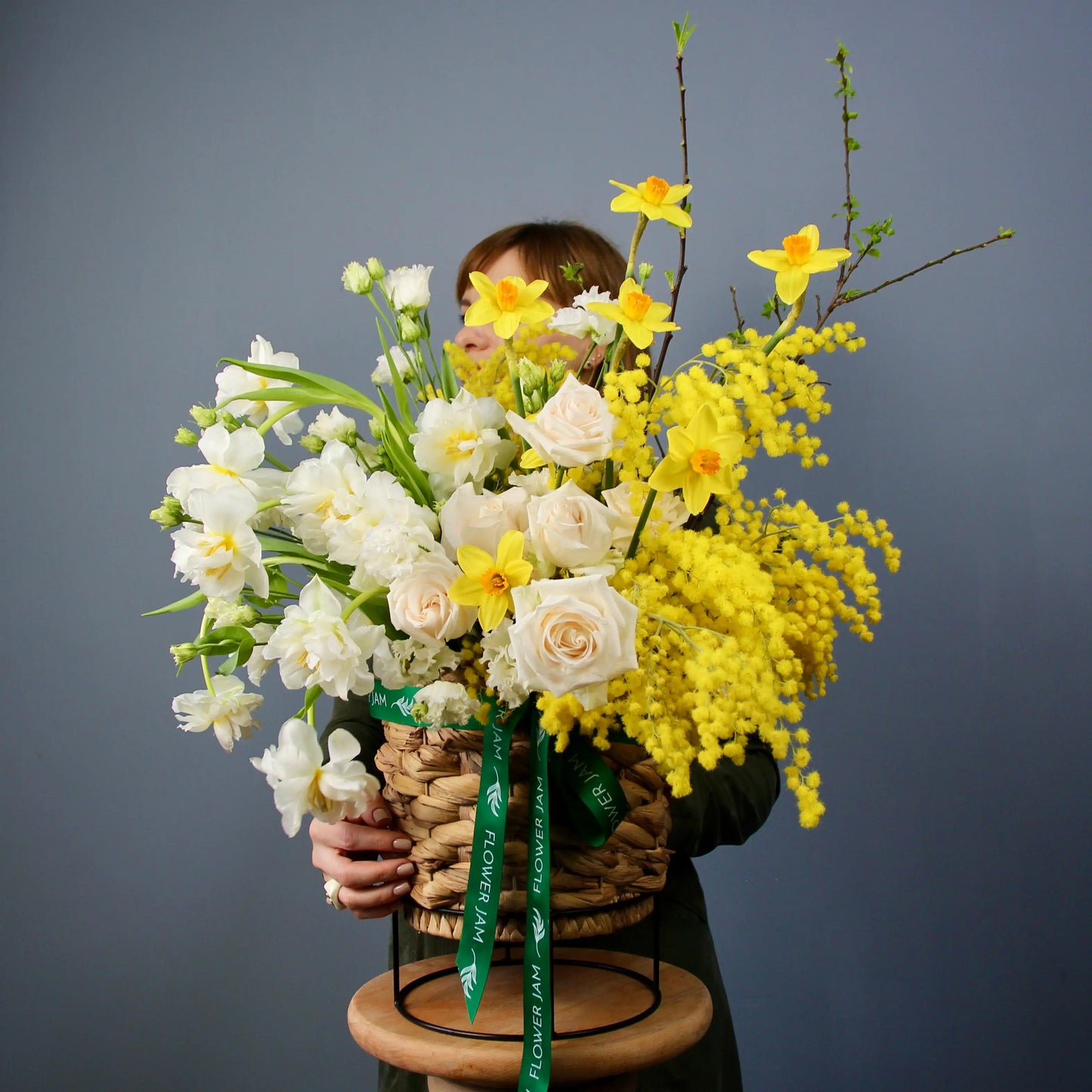 flower bouquet of mimosa, rose and narcissus in a basket floqwer bouquet in genova