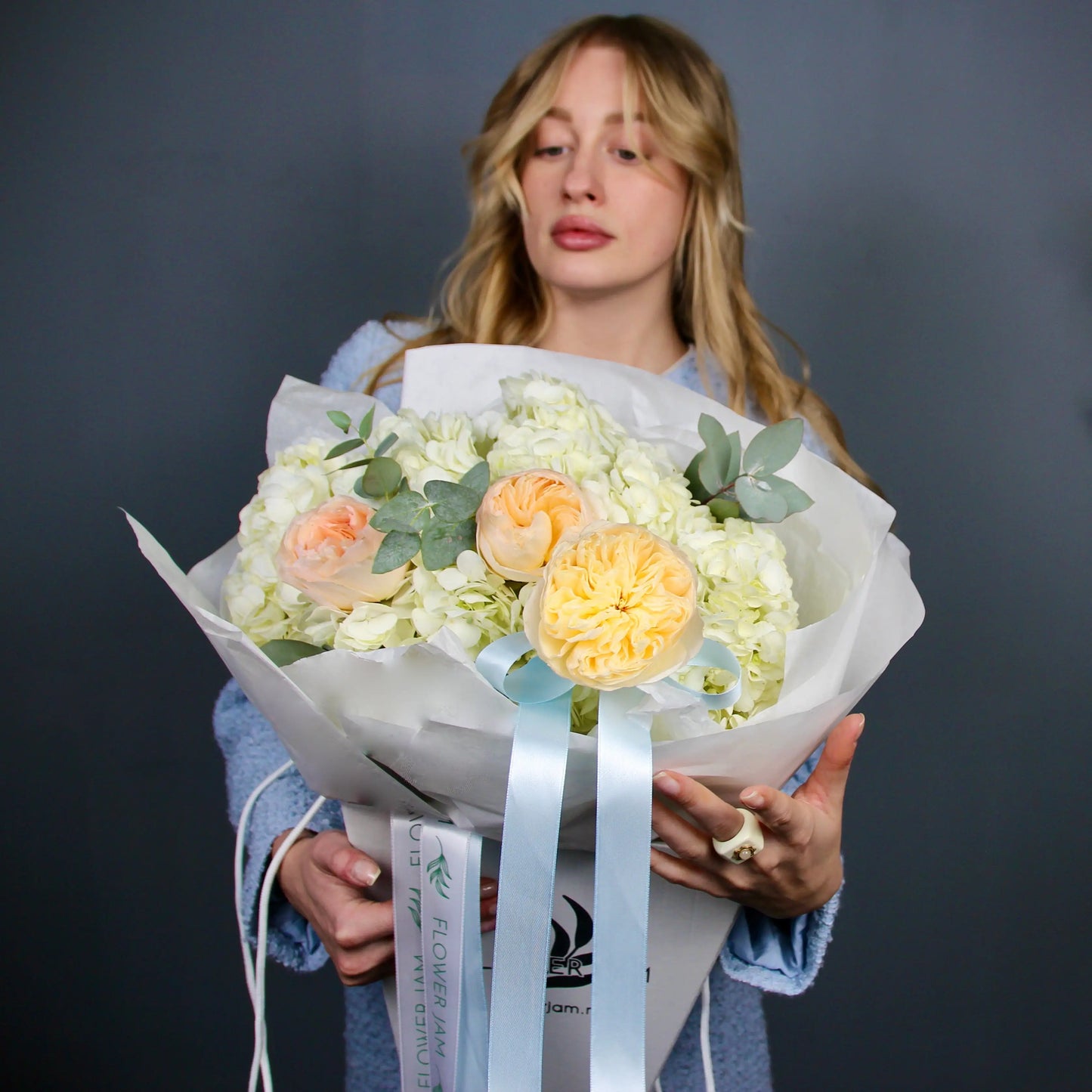 bouquet of flowers with a woman in a light blue dress