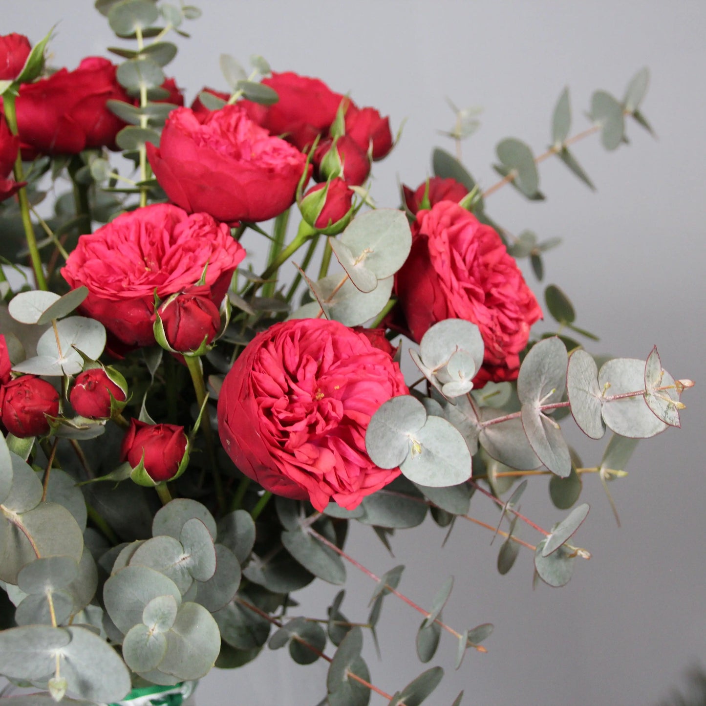a bouquet of red english garden roses and eucalipt