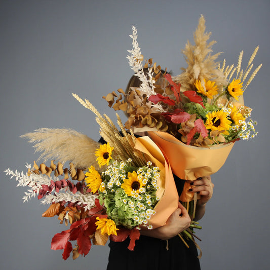 colorful summer bouquet wih brown, yellow, red and white flowers