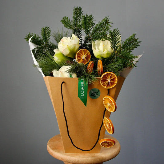 bouquet of spruce branches, white flowers, and oranges