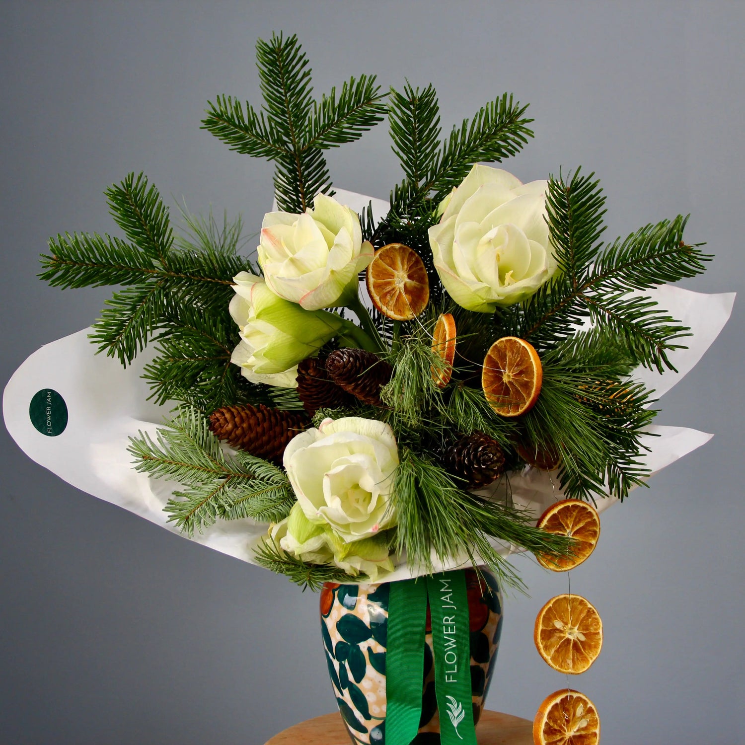 bouquet of spruce branches, white flowers, and oranges