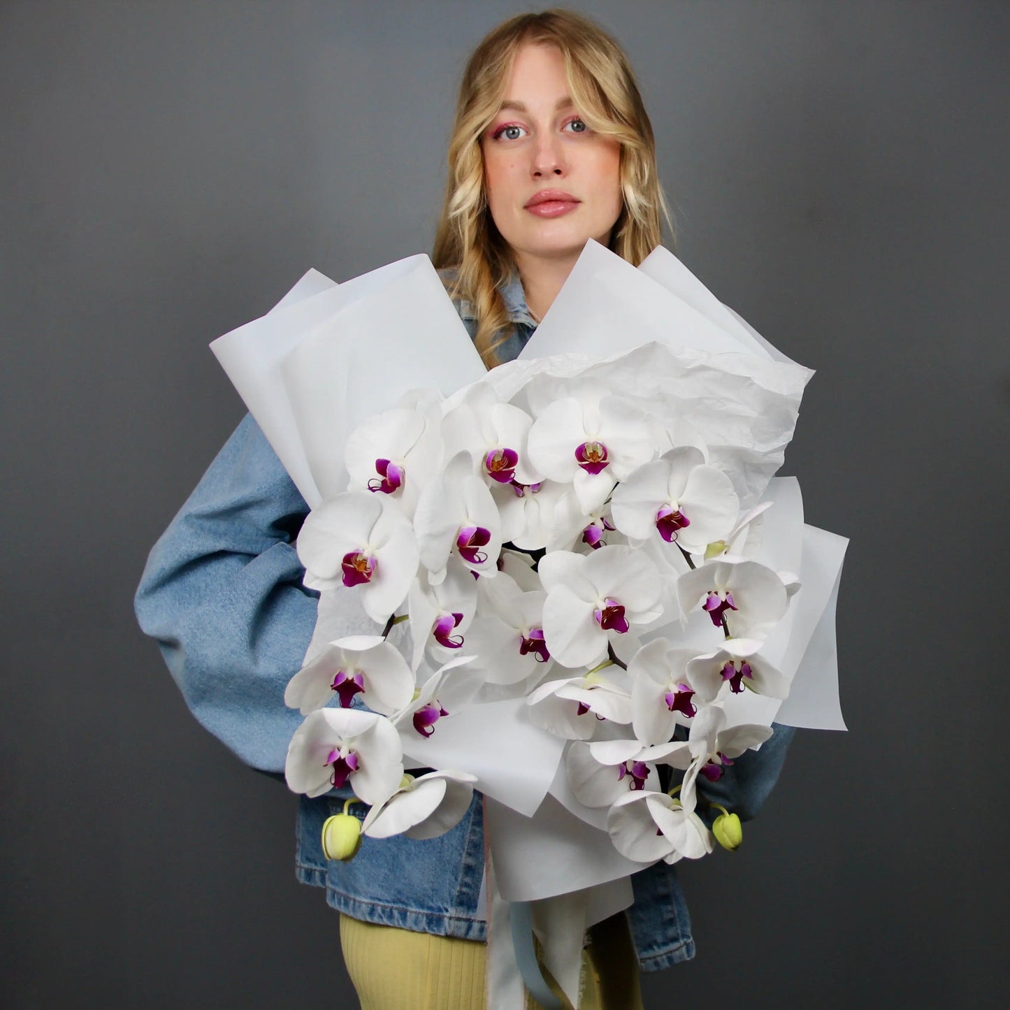woman holding white Phalaenopsis bouquet  Genoa
