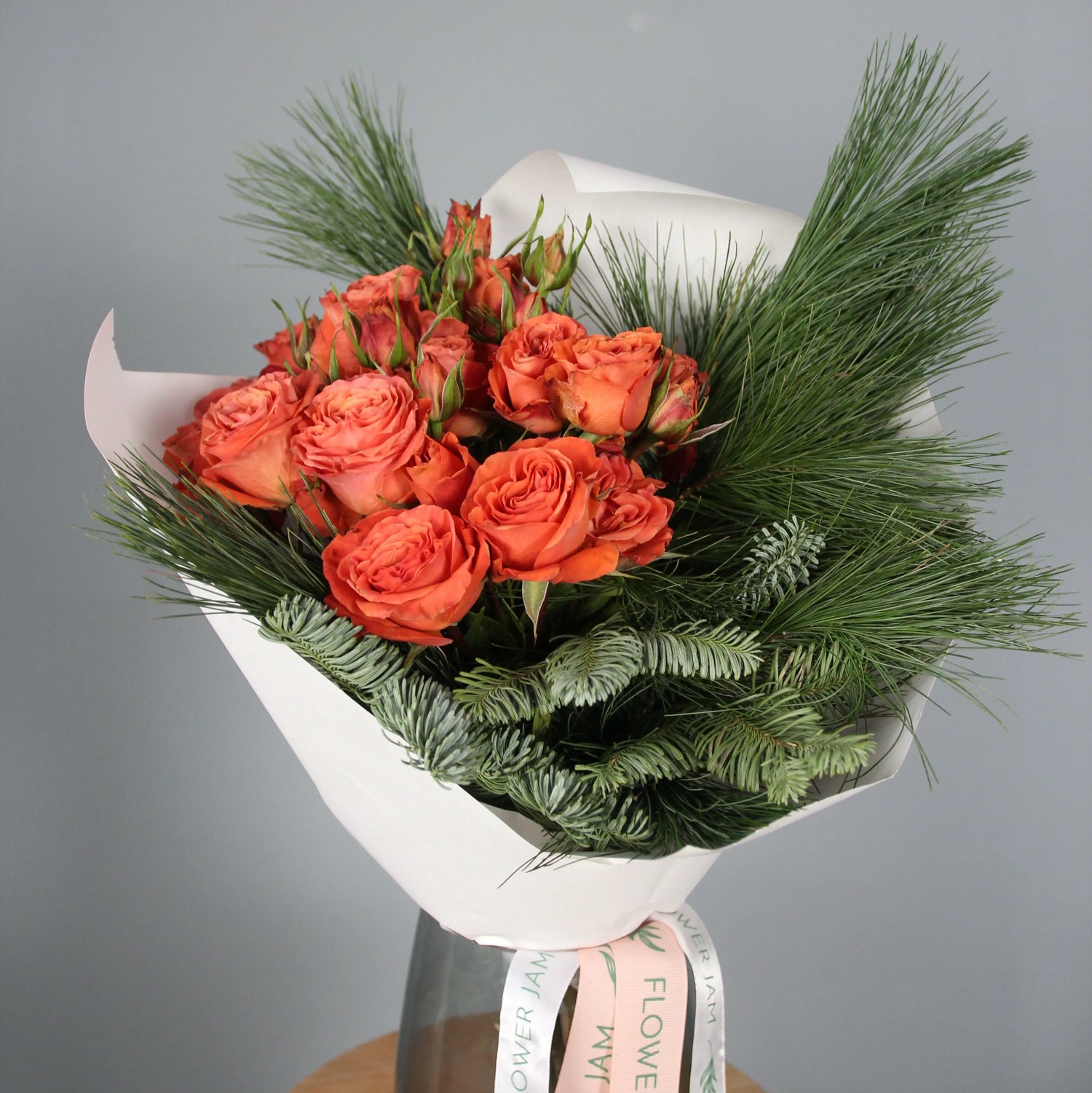 Orange roses and spruce branches bouquet  Bouquet of Flowers