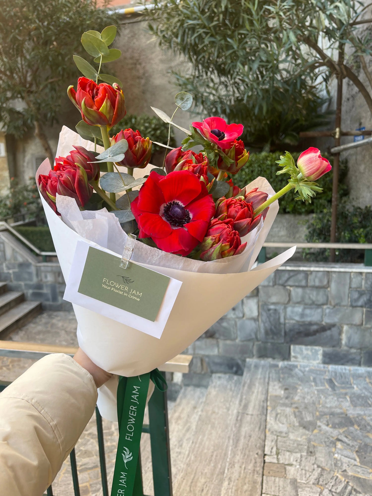 red bouquet of anemone and tulips