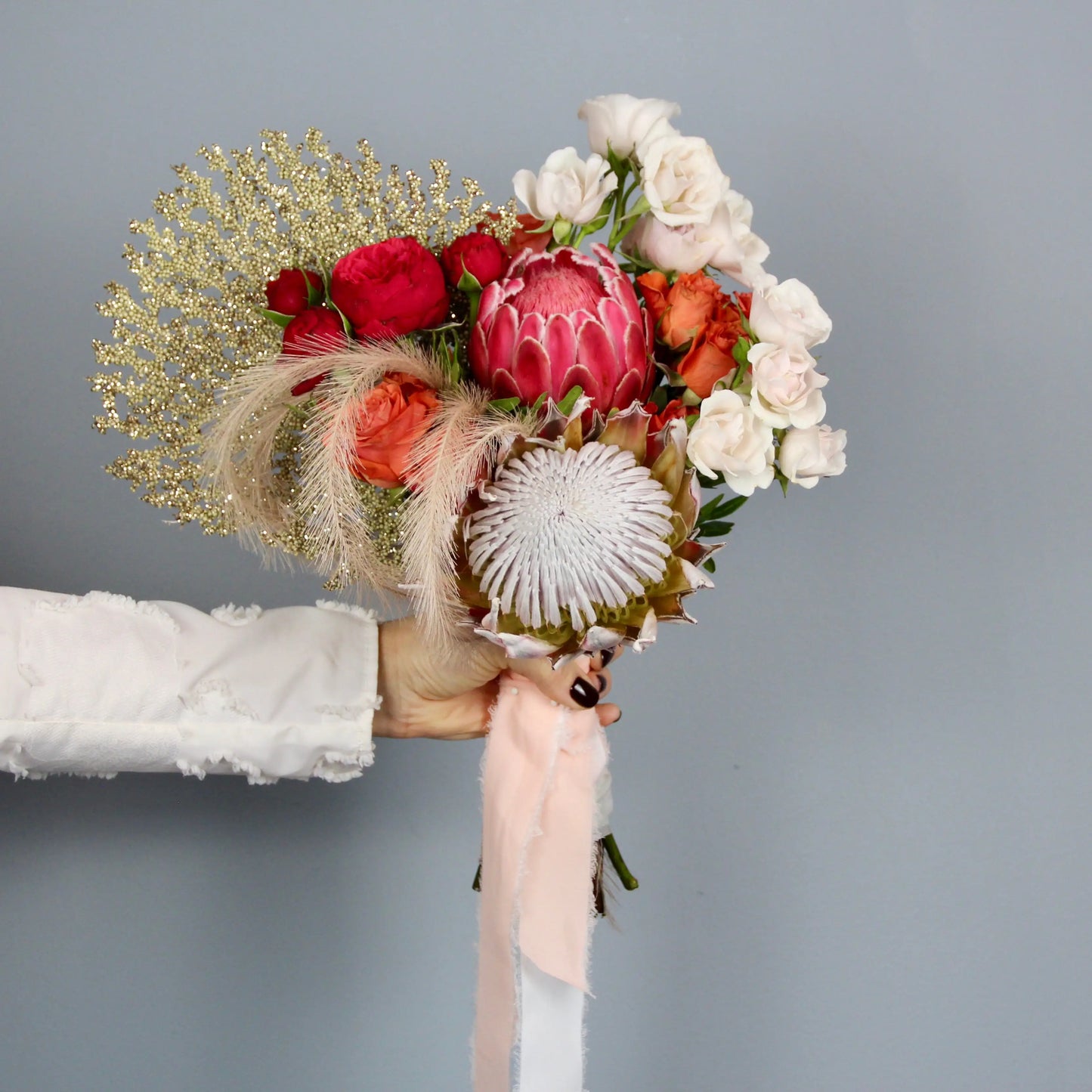 flower arrangement out of red, orange and white flowers