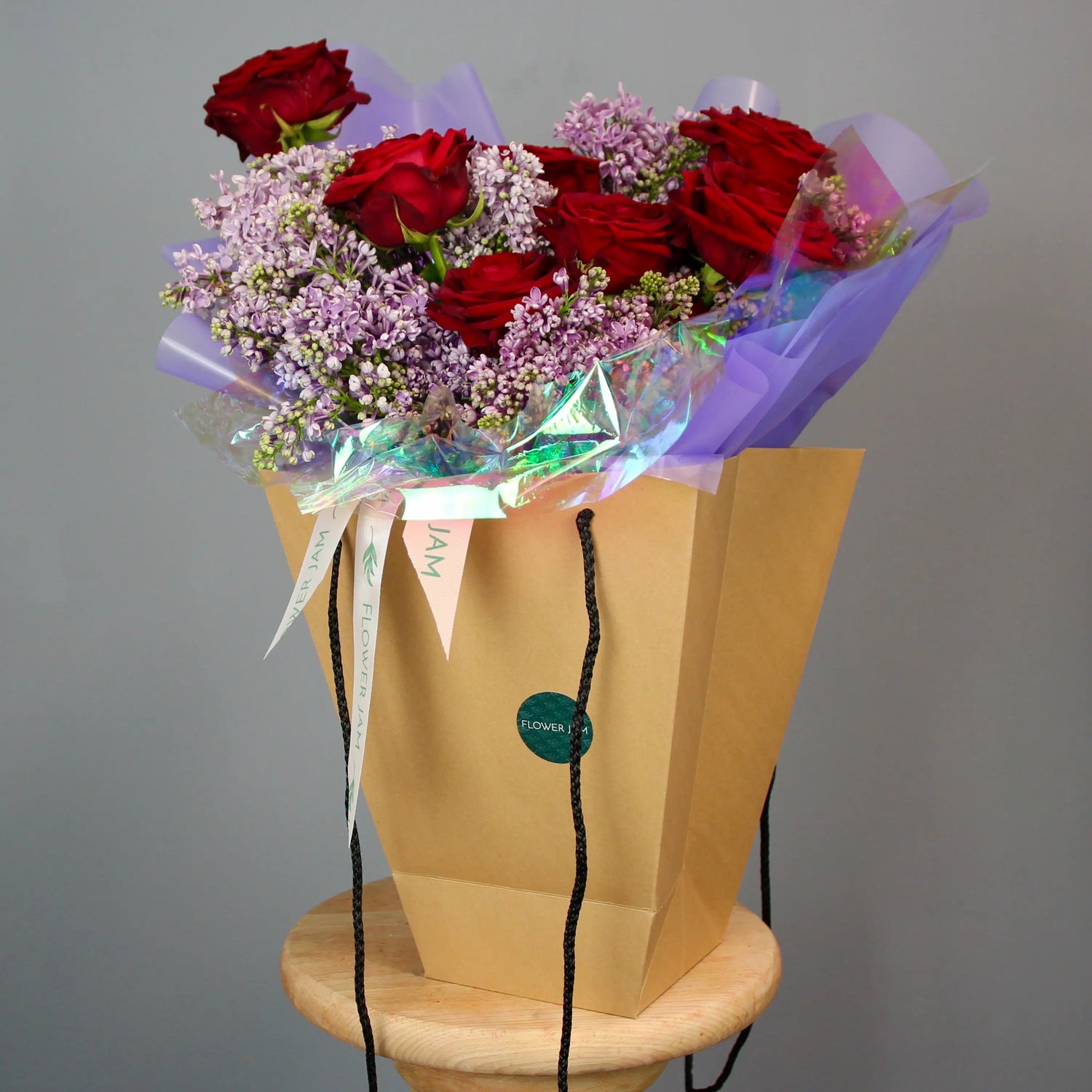 red roses and violet syringa bouquet
