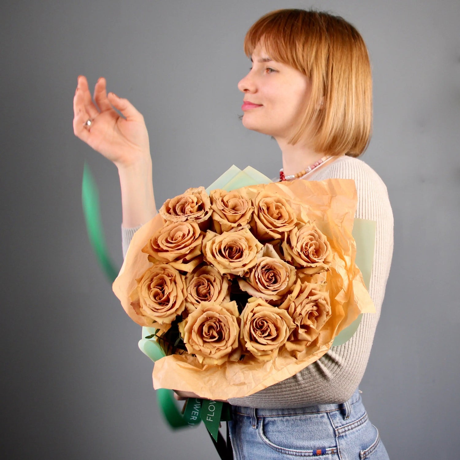 woman holding a bouquet of golden roses