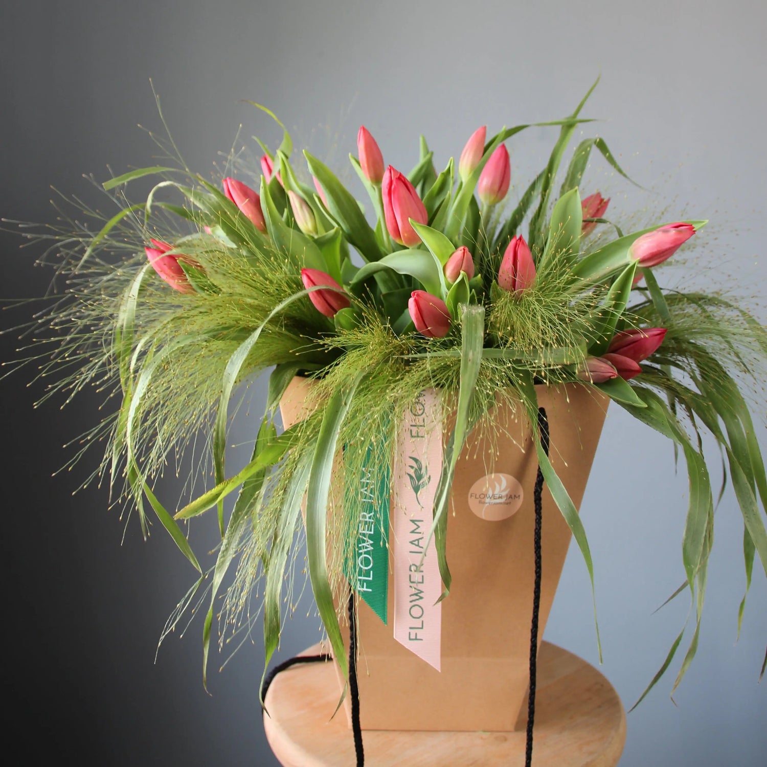 a big beautiful bouquet of pink tulips and greenery