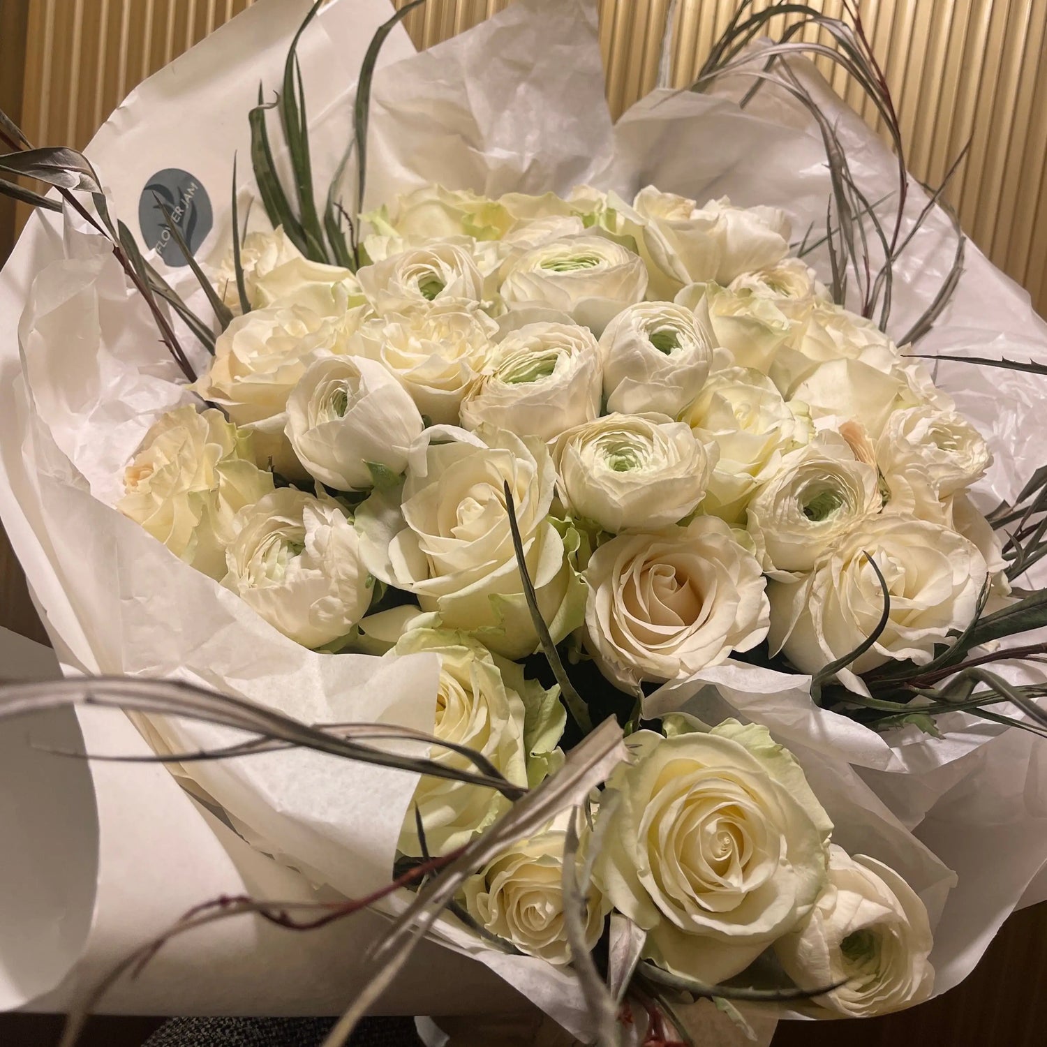 bridal bouquet of white roses and ranunculus